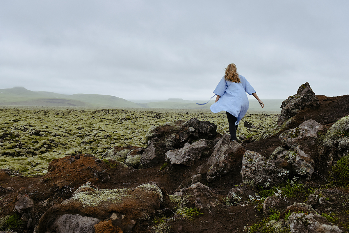 Young beautiful woman in an old moss-covered lava field  volcani