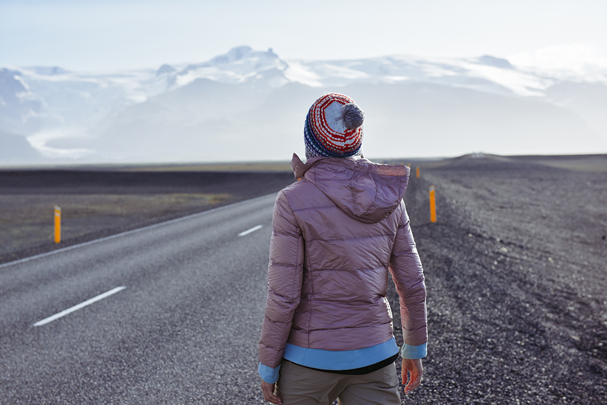 Woman walking on the road in Iceland